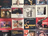 various movie posters are displayed on a wall in a room