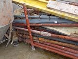 a pile of pipes and a cement mixer in a room