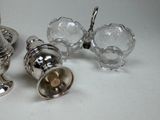 three silver objects sitting on a table next to each other