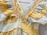 a close up of a yellow and blue dress on a mannequin
