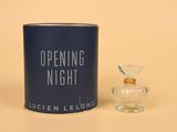 an image of a bottle of perfume next to a canister