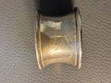a close up of a silver ring with a black band