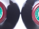 two bottles of wine that are sitting next to each other