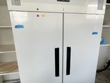 a white freezer that is in the middle of a room