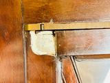 a close up of a wooden door with a metal latch on it