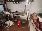 an image of a kitchen with a lot of clutter on the floor