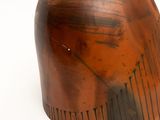 a brown vase that is sitting on a white surface