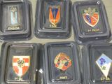 several different types of badges in plastic containers on a table