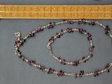 beaded necklace and bracelet with garnets and a gold bracelet