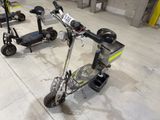 two electric scooters that are parked in a garage