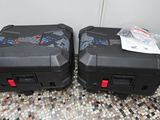 two suitcases that are sitting on a tiled floor