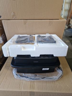 a black and white microwave sitting on top of a cardboard box