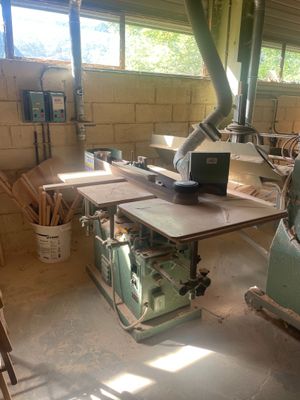 an image of a woodworking shop with a table sawing machine