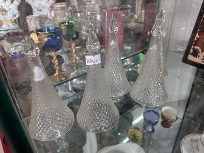 three glass vases on display in a glass case
