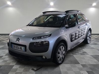 a picture of a silver citrole parked on a checkered floor