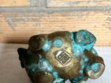 an image of a metal object on a table with a wooden background
