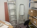 a ladder leaning against a wall next to a chair