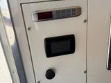 a close up of a gas pump with a clock on it