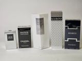 four different types of perfumes are lined up on a white surface