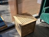 a basket that is sitting on the floor in front of a window