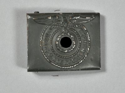a silver lighter that has a black hole in it