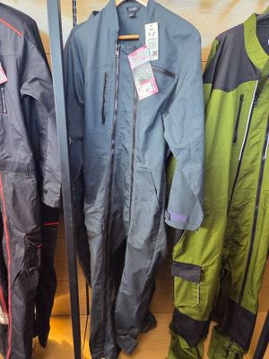 many different types of ski suits on display in a store
