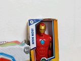 a box of toys and a toy iron man figure on a table