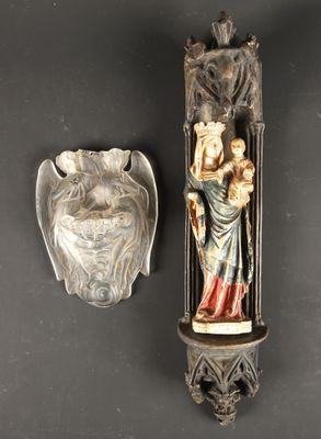 a statue of a woman holding a baby and a bowl