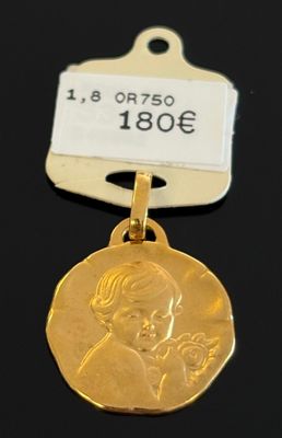 l'image d'une médaille d'or sur laquelle figure le visage d'une femme