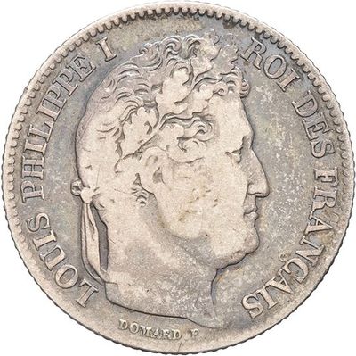 an old silver coin with a man ' s head on it