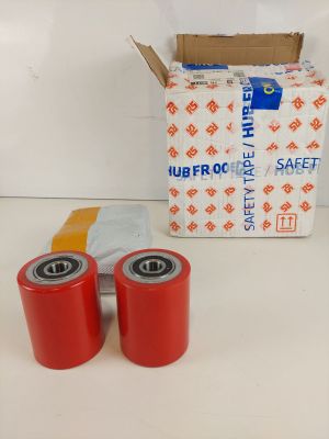 two red rollers are sitting next to a box of red tape