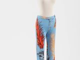 un mannequin portant un pantalon bleu orné de plumes orange