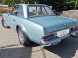 a blue car that is parked on the side of the road