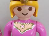 a pink toy with a gold crown on it ' s head and a pink toy with a gold crown on it ' s head