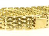 gros plan d'un bracelet en or sur fond blanc
