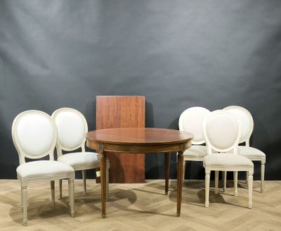 four chairs and a table on a wooden floor