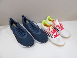 three pairs of tennis shoes are lined up on a table