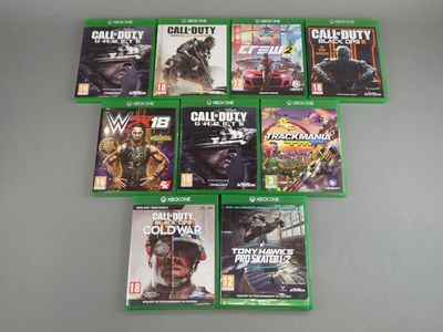 a lot of xbox game covers on the table