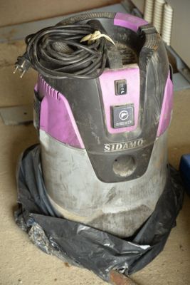 a vacuum that is sitting on the floor in the room