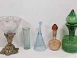 many different colored glass vases sitting on a table