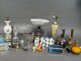 many different types of glass items displayed on the table