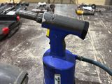 an image of a blue and black electric drill