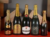 several bottles of champagne are lined up on a red table