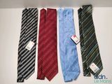 four different colored ties are lined up on a white surface