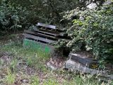 a wooden bench in the middle of a grassy area