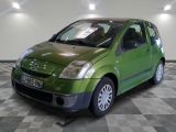 a small green car that is parked in a room