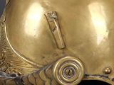 an image of a gold helmet on a black background