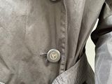 a man wearing a jacket with buttons on it