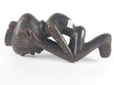 sculpture of a woman laying on her back on a white surface