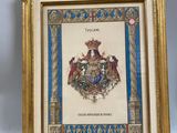 an old framed picture of a coat of arms with a gold frame